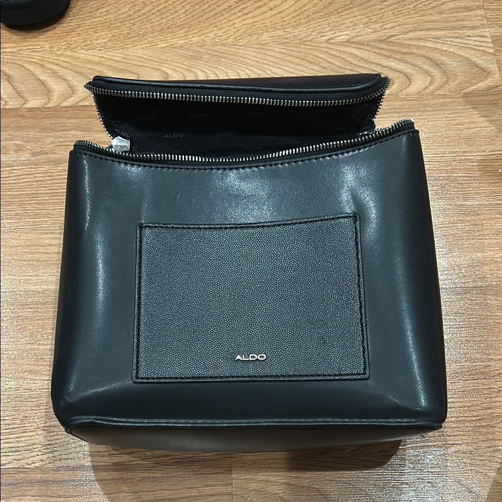Aldo Black handbag and book back